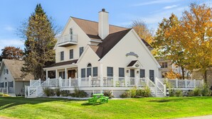 A two-story house with a porch, a chimney, and a number 116 sign. - York Beach Getaway (Razzle Dazzle House) (York)