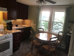 Enjoy cooking in this well-equipped kitchen with a stove, sink, and ample counter space.