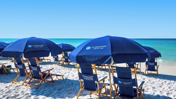Beach chairs and umbrellas at Pelican Beach Resort. - Two Balconies, Sunset/Gulf View, Corner Unit (Destin)