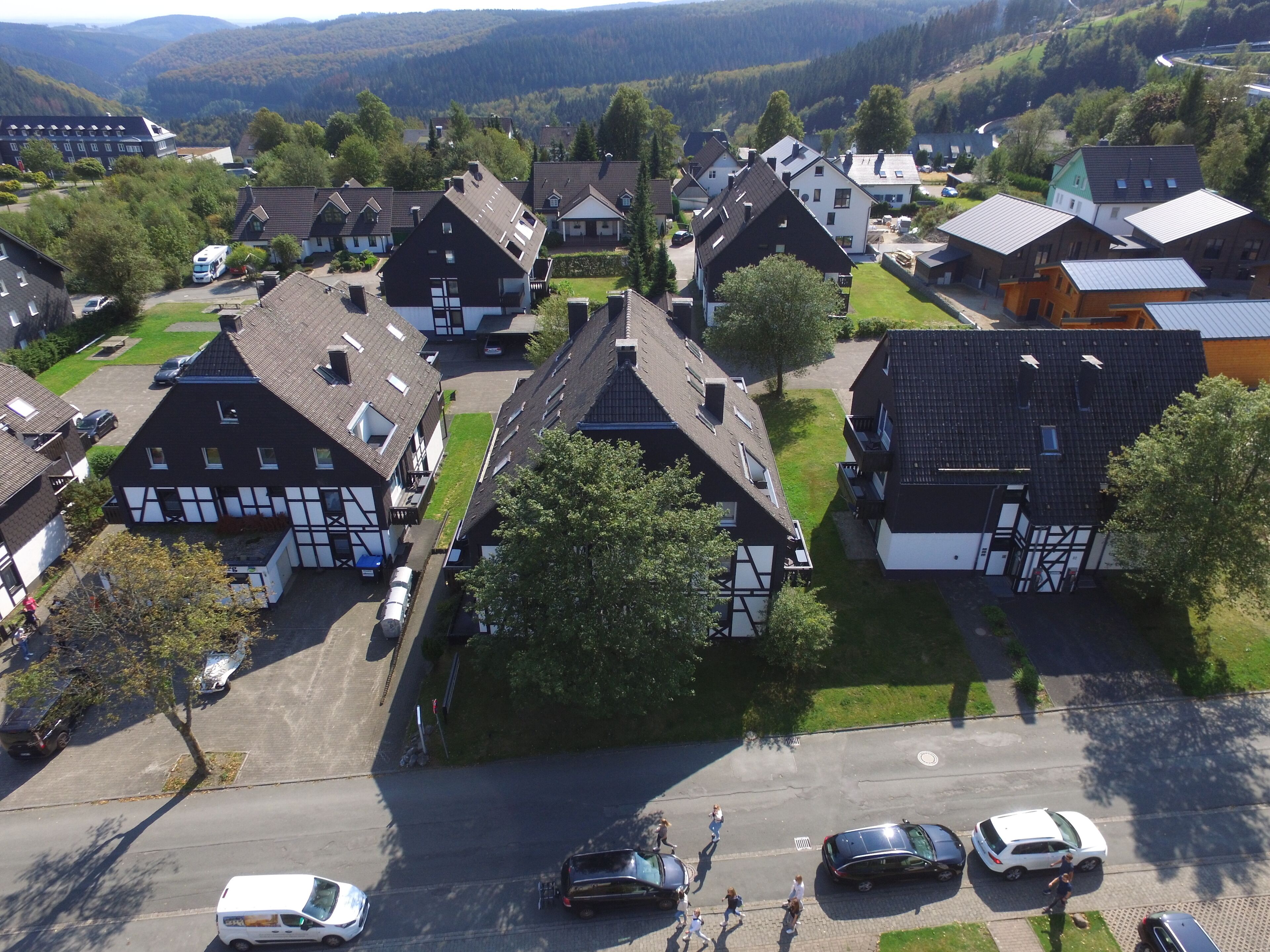A residential area with houses featuring steep roofs and a mix of modern and traditional architecture.