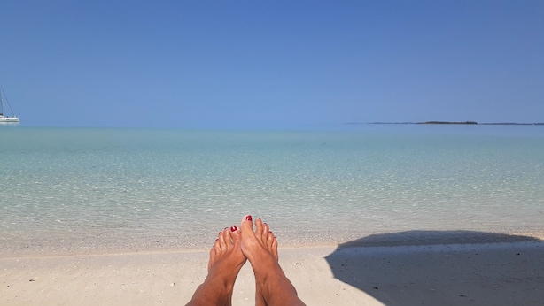 A beach with clear turquoise water and a distant island. - "We Make Your Stay In The Bahamas Both Comfortable and Affordable" (Governors Harbour)