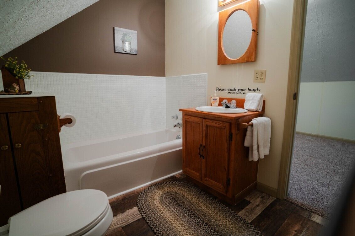 A bathroom with a bathtub, a sink, and a toilet.