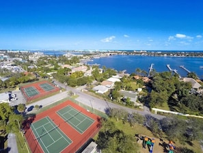 A coastal cityscape with multiple tennis courts, a marina, and residential buildings. - 3/2 Heated Private Pool, 5 Min to Beach (Lantana)