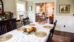 A dining area with a table set for four, surrounded by chairs, and a kitchen in the background. - Charm and Comfort in Quiet Lodi Neighborhood (Lodi)