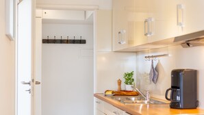 A modern kitchen with a wooden countertop, stainless steel sink, and a coffee maker. - Wonderful holiday flat with ocean view to the island Amrum - Seaview, Dogfriendl (Wittdün)