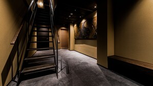 A staircase with a wooden handrail leading to a landing. - Hotel ZIZI Kyoto Gion (Kyoto)