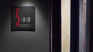A hallway with a sign indicating the 5th floor.