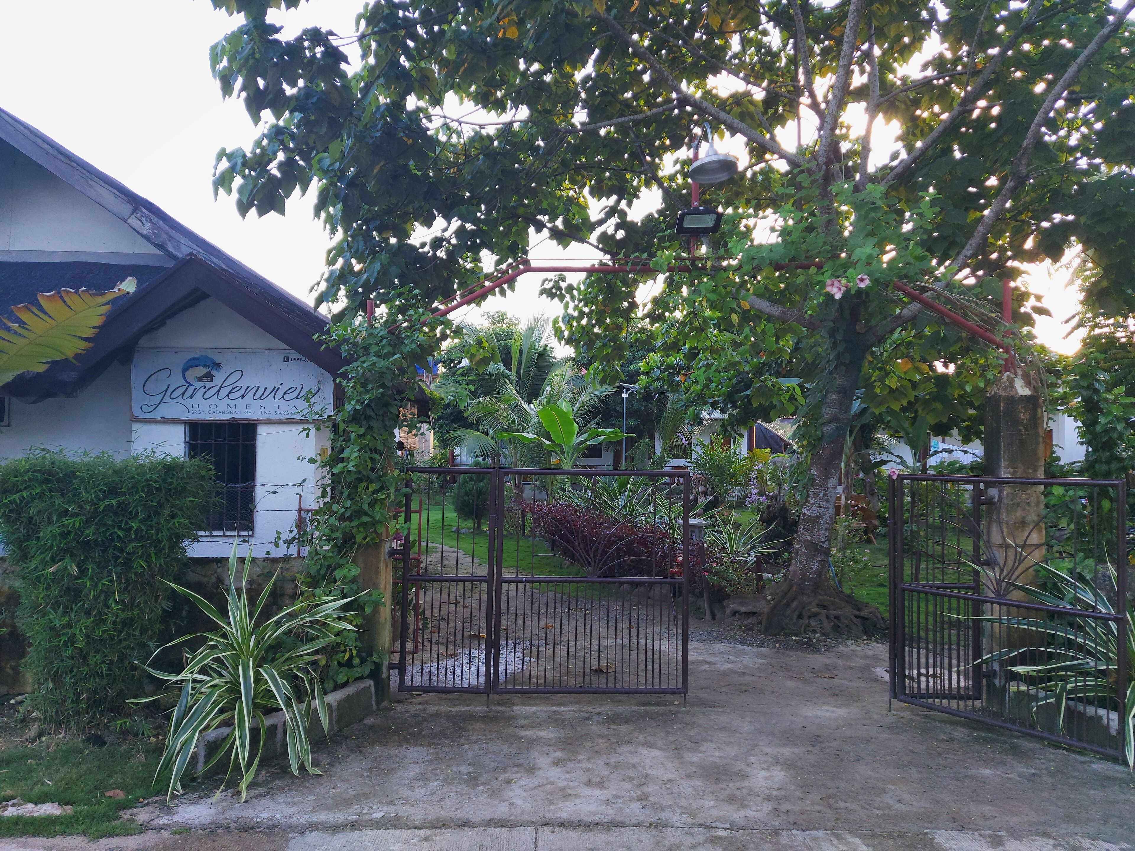 A gated entrance to a property named 'Gardenview' with a sign indicating it is a home.