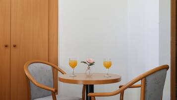 Basic Triple Room, Courtyard View | Living area | Flat-screen TV