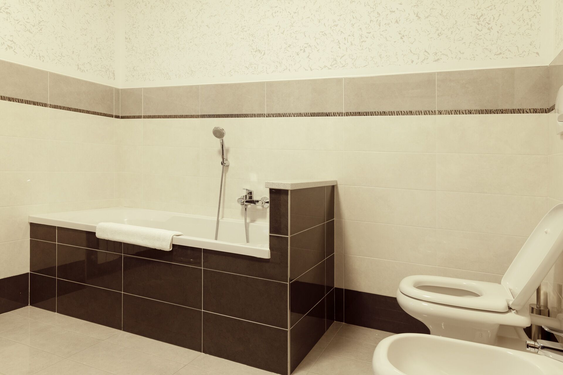 A bathroom with a bathtub, a toilet, and a shower.