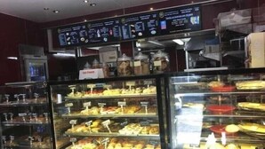 A bakery display case with various baked goods. - Chapel Apartments (Aberdeen)