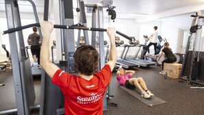 A gym with exercise equipment, treadmills, and a person using a pull-up bar. - Førde Sommarhotell (Sunnfjord)