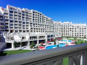 A large hotel with multiple balconies, a swimming pool, and a well-maintained lawn. - Varna South Bay Apart Complex (Varna)