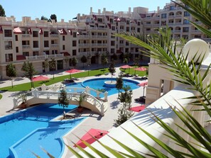 A hotel with multiple balconies, a swimming pool, and a well-maintained lawn area. - Varna South Bay Apart Complex (Varna)