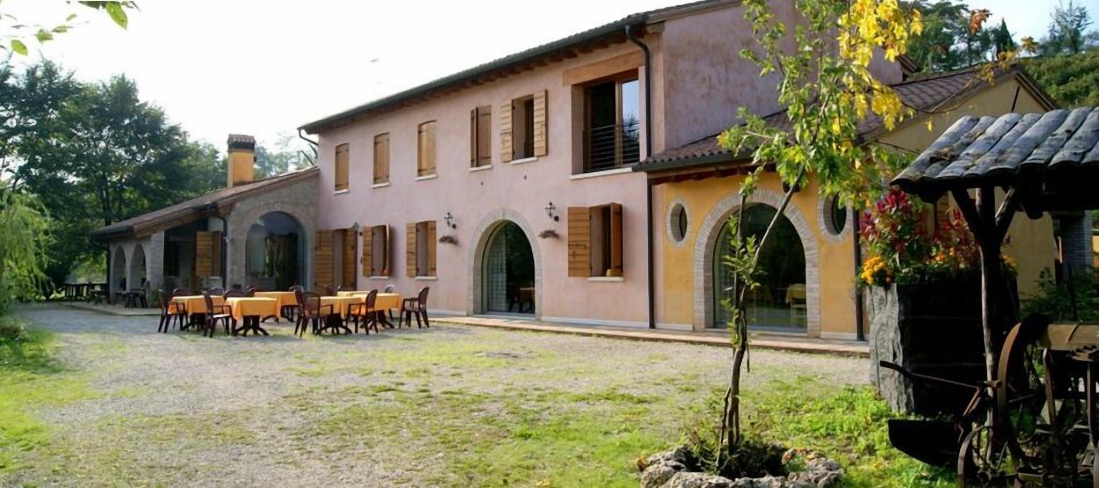 A building with a courtyard, outdoor seating, and a small garden area.