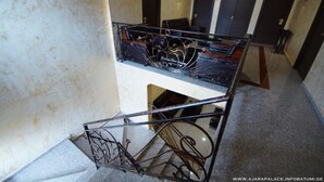 Un interior de diversos nivells amb una escala i una barana de metall.