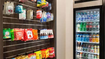 A vending machine stocked with various beverages and snacks.
