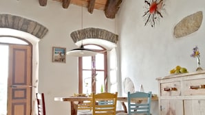 A dining area with a wooden table, chairs, and a cabinet.