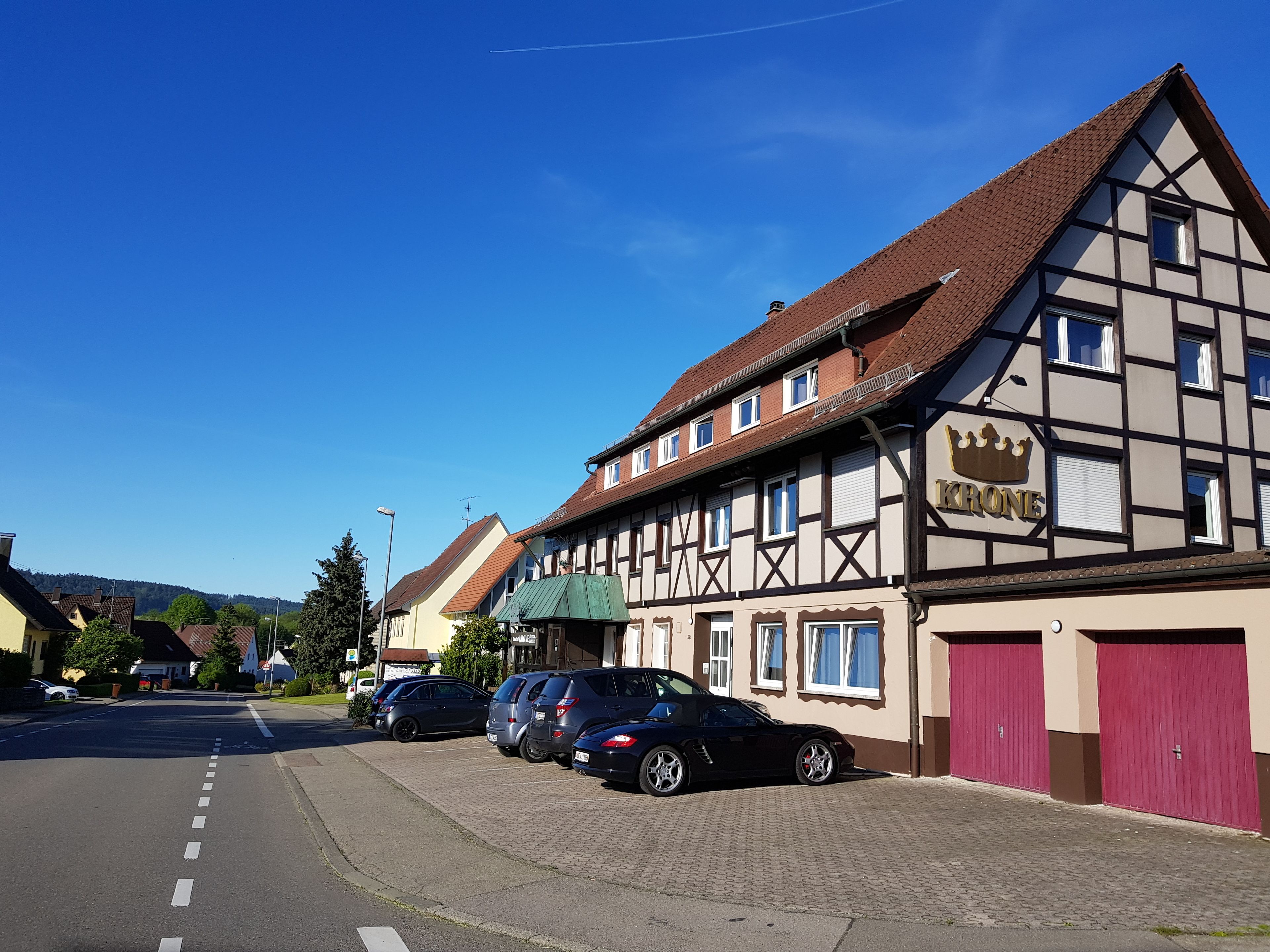 A traditional half-timbered building with a sign reading "KRONE".