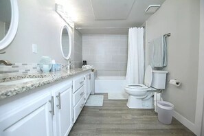 A modern bathroom with a vanity, sink, mirror, toilet, and shower. - Beautifully Remodeled Condo - Fountain Views (St. George)