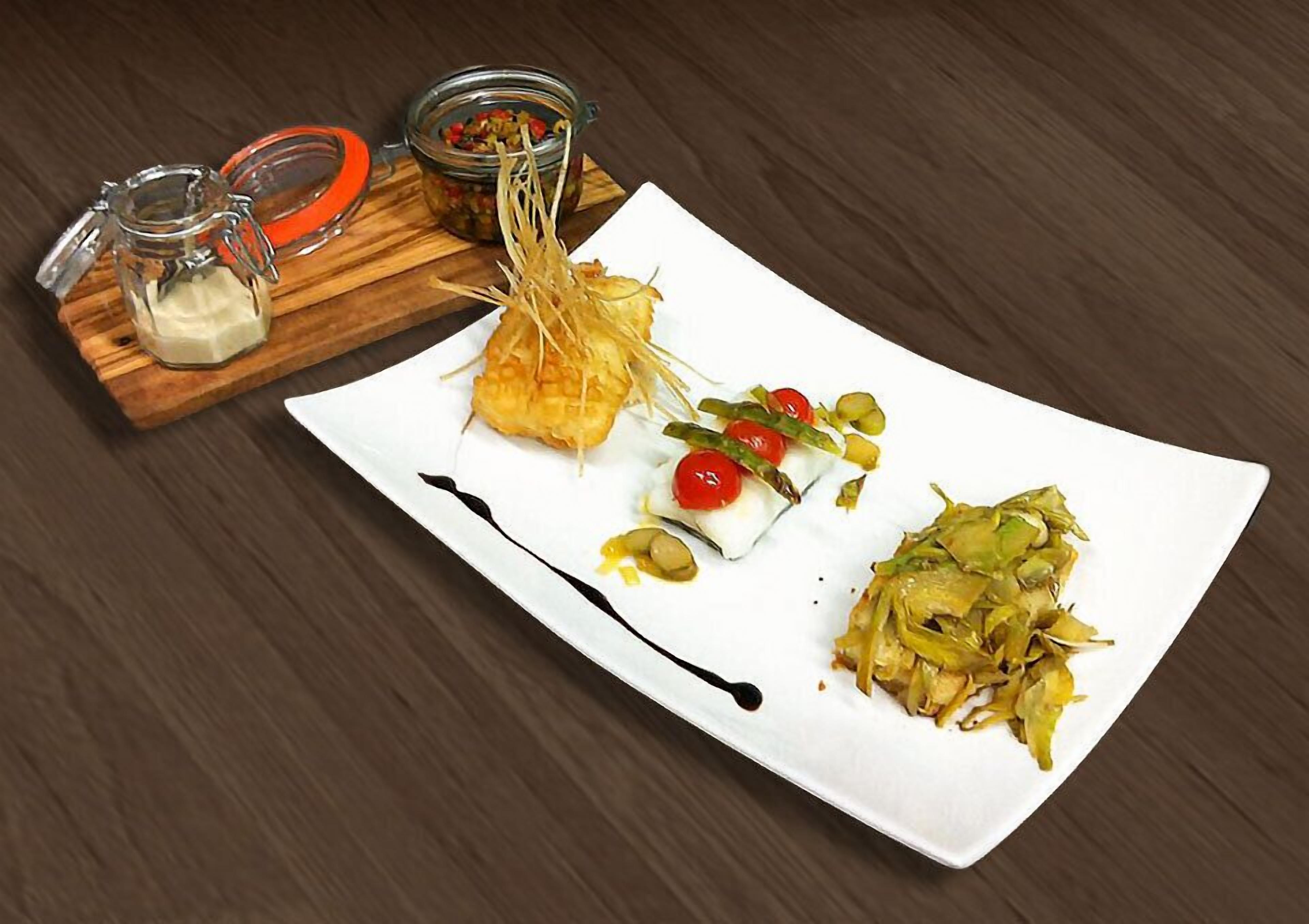 Un plato blanco con diversos alimentos, una tabla de madera con dos tarros de vidrio y una mesa de madera oscura.