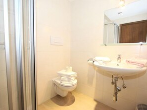 A bathroom with a toilet, sink, and shower. - Römerhof by Interhome (Fügen)