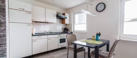 Departamento Deluxe, vista al patio | Cocina privada | Refrigerador con congelador, microondas, horno y parrilla de estufa