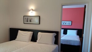 A hotel room with a bed, a nightstand, and a wall-mounted light fixture. - Hotel Riomar (Lagos)