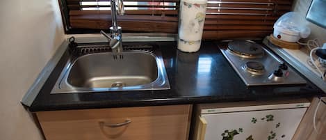 Fridge, microwave, coffee/tea maker, cookware/dishes/utensils