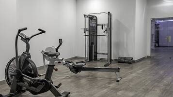 Una palestra con una cyclette, una sbarra per trazioni e una macchina per pesi.