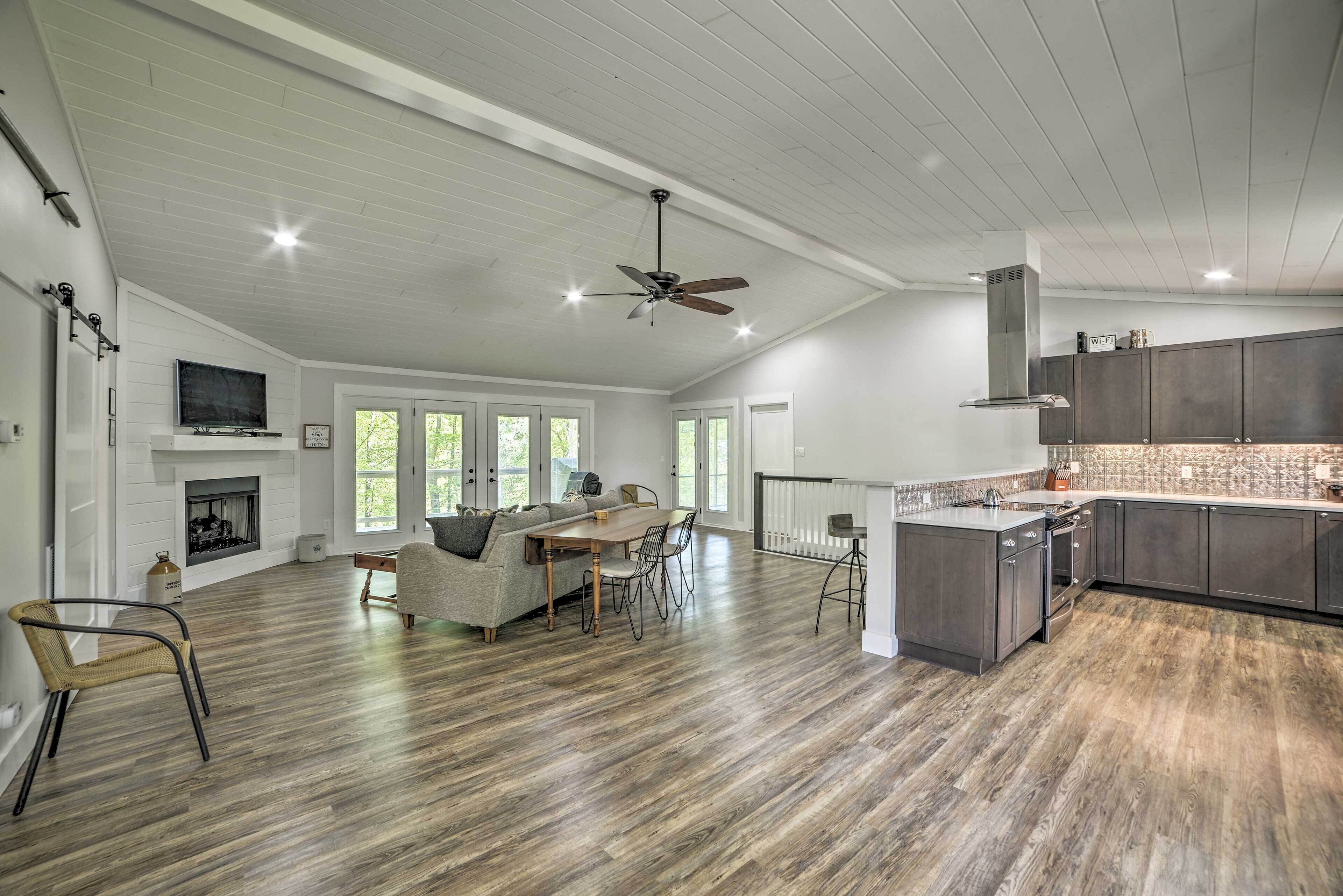 A spacious living area with a fireplace, dining table, and comfortable seating.
