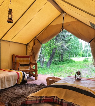 1 bedroom, bed sheets. Mountain Man Wall Tent campsite 5 Caribou Trail Wagon Camp