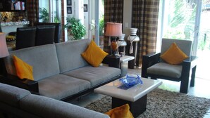 A living room with a grey sofa, yellow cushions, a coffee table, and a lamp. - Downtown Penthouse-Style Apartment (Puerto Vallarta)