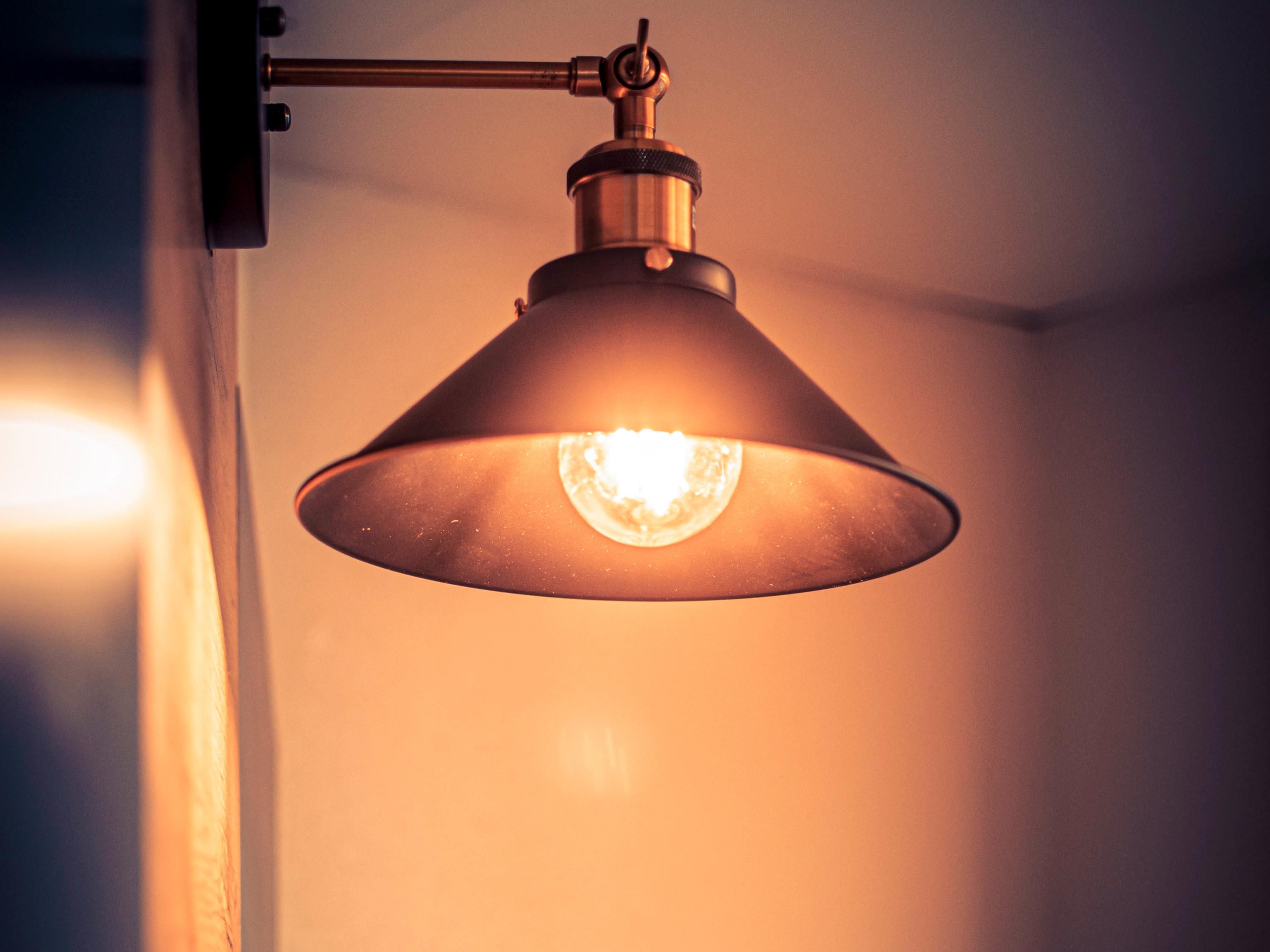 A pendant light fixture with a visible bulb and a metallic base.