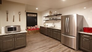 A modern kitchen with stainless steel appliances, wooden cabinets, and a chalkboard sign. - Large winter retreat just minutes from Dodge Ridge and Leland Snow Park (Mi-Wuk Village)