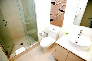 A modern bathroom with a glass shower enclosure, a toilet, and a sink with a mirror above. - Bw-1208b (Hallandale Beach)