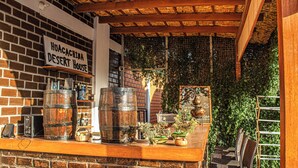 A brick wall with a sign reading "Huacachina Desert House".