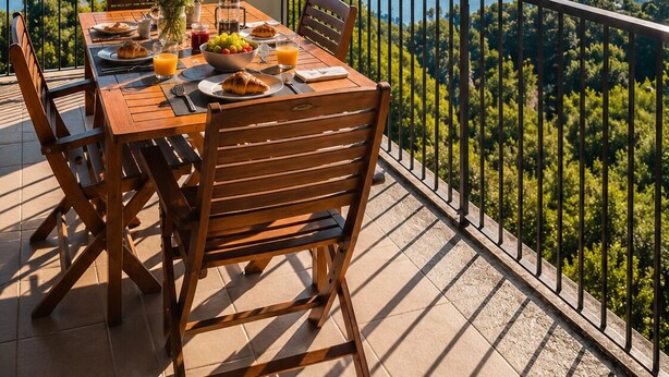 A wooden table set with breakfast on a balcony overlooking a lake and mountains. - Panoramic View of Lake Maggiore Near Stresa • Private Garden & Parking (Levo di Stresa)