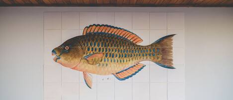 A fish mural on a wall.