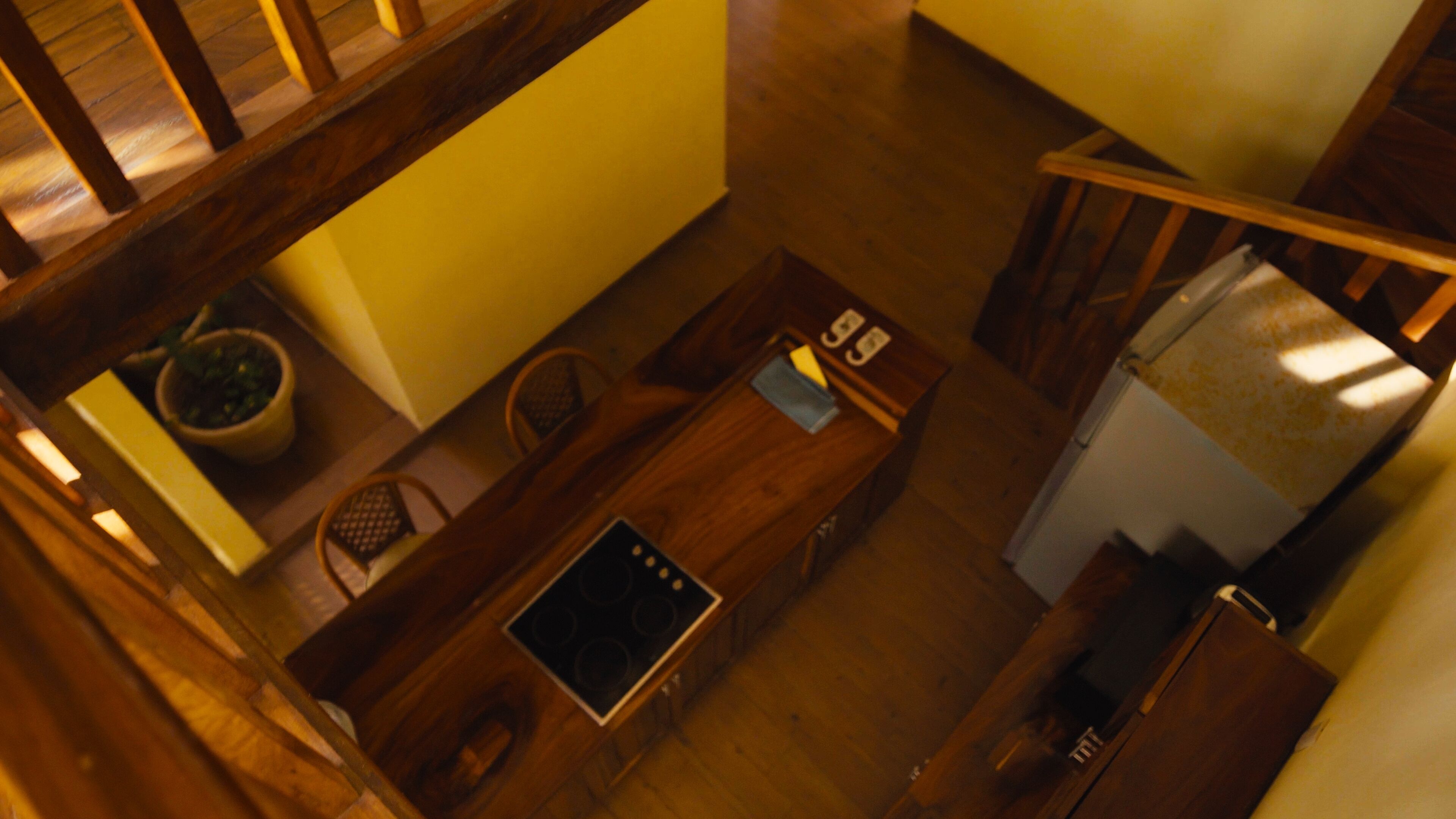 A kitchen with wooden cabinets, a stove, and a refrigerator.