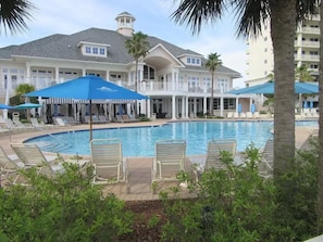 Relax by the inviting pool surrounded by lounge chairs and shaded by umbrellas.