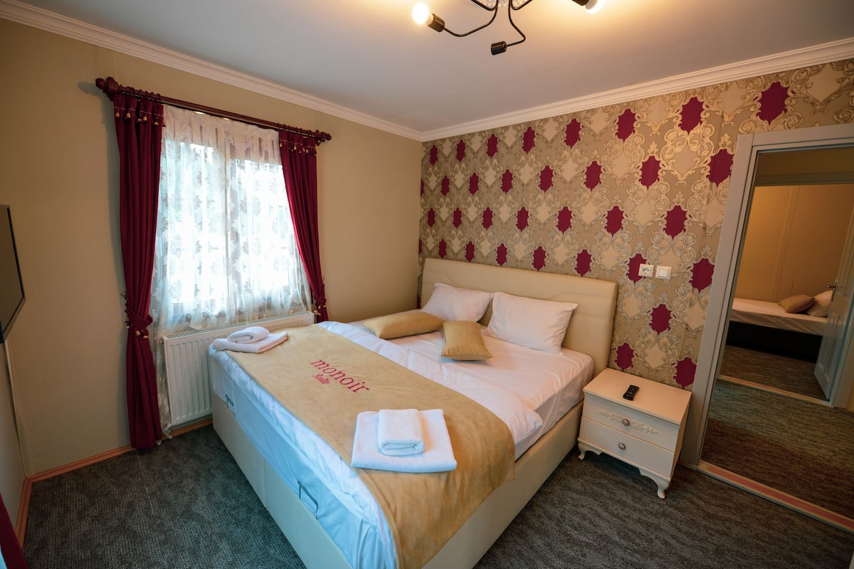 Premium bedding, desk, laptop workspace, blackout curtains