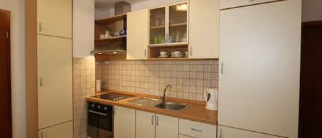 Fridge, stovetop, coffee/tea maker, cookware/dishes/utensils