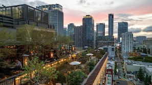 A rooftop garden with outdoor seating, surrounded by high-rise buildings. - Downtown Los Angeles Proper Hotel, a Member of Design Hotels (Los Angeles)