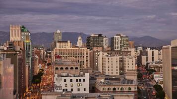 A cityscape with a variety of buildings, including a prominent hotel with a sign that reads "United Artists."