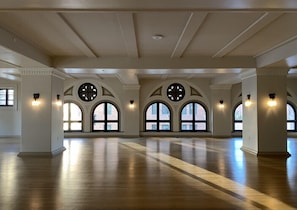 A spacious hall with large arched windows and wall-mounted lighting fixtures. - Downtown Los Angeles Proper Hotel, a Member of Design Hotels (Los Angeles)