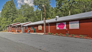 A row of red-roofed buildings with signs advertising a restaurant.