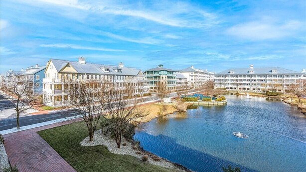 Ein Hotel am Wasserufer mit mehreren Gebäuden, einem Fluss und einem Fußweg.