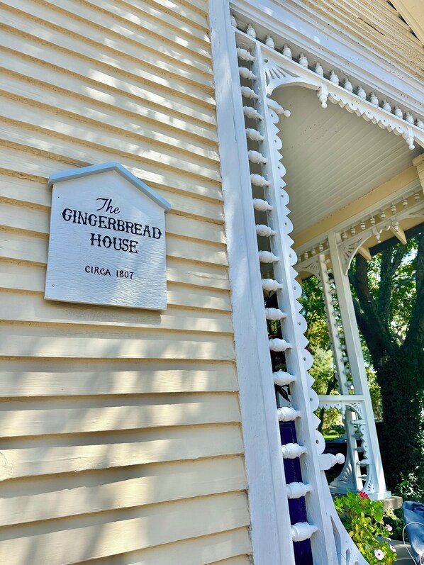 Een huis met een bordje waarop staat: The Gingerbread House, circa 1807.