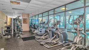 A gym with multiple cardio machines and weightlifting equipment. - Palace 105 (Myrtle Beach)